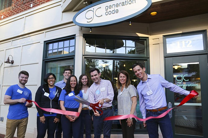 Generation Code staff gather around CEO Terry McDonough, Mayor Laurie DiRocco and Strayer Education CFO and Vienna local, Dan Jackson, to celebrate the opening the new Vienna coding lab. 