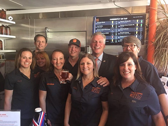 Virginia Gov. Terry McAuliffe toured the Lake Anne Brew House on Friday, June 9, and staff taught him how to pour his own beer from the tap.