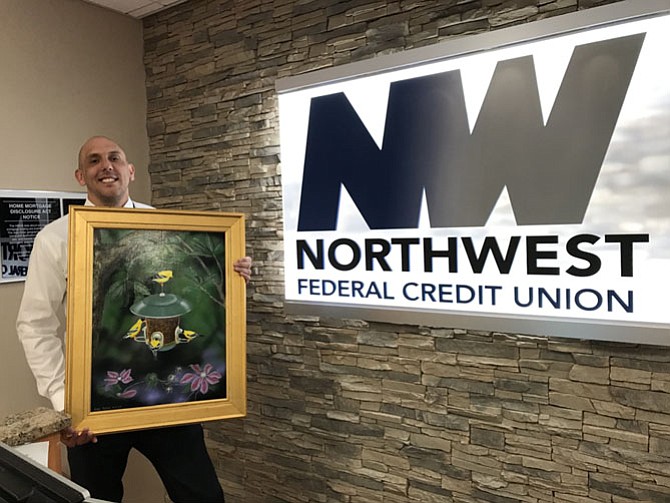 Joe Talmadge, vice president of Mortgage Lending, Northwest Federal Credit Union in Herndon shows off one of the first donated works of locally sourced original art to support NWFCU Foundation's Night of Magic 2017, an exciting evening of fun just for critically ill children at INOVA Fairfax Children's Hospital and their families. 