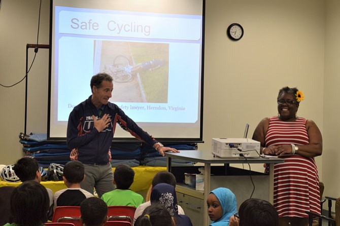 Karen Pope introduces Doug Landau to his school-aged audience.