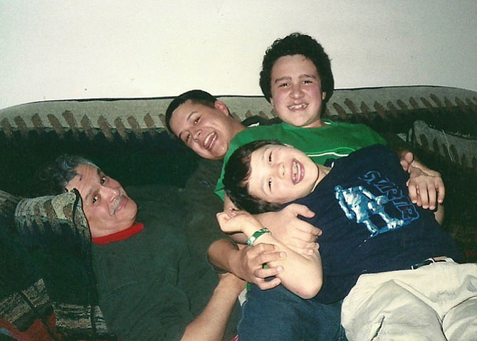 The Garcia Sons pouncing on top of Dad at home, 2005, all raised in Springfield, since birth. Foreground - Christian, 21;  left - Erik, 37; top - Nick, 24 and Dad, ageless.