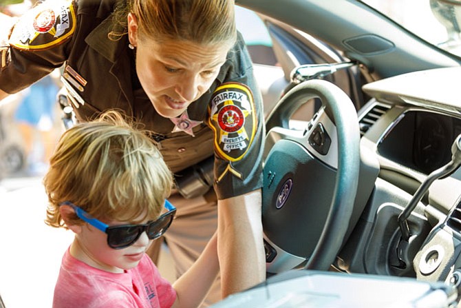 Rory Mogle, 4, gets a look inside a patrol car at the Celebrate Fairfax Festival.
