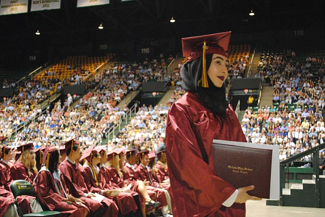 Students received their diplomas and stopped to have their pictures taken once they stepped off the stage.