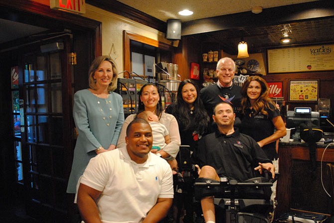 U.S. Rep. Barbara Comstock (R-10) came to support the families helped by the Gary Sinise Foundation. From left: Comstock, Capt. Jeremy Haynes, Chelsea Haynes holding their child Joseph, Claudia Avila, Luis Avila, Bob Nelson and Linda Lowry.