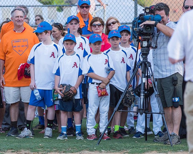 Alexandria Little League players listen to remarks prior to taking the field June 20 at Simpson Park.