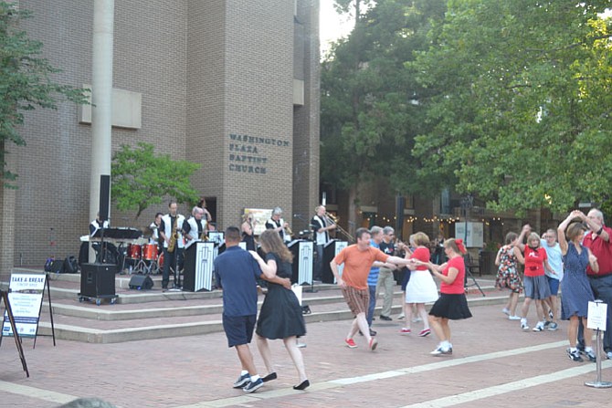 Couples swing dance to music played by Radio King Orchestra.