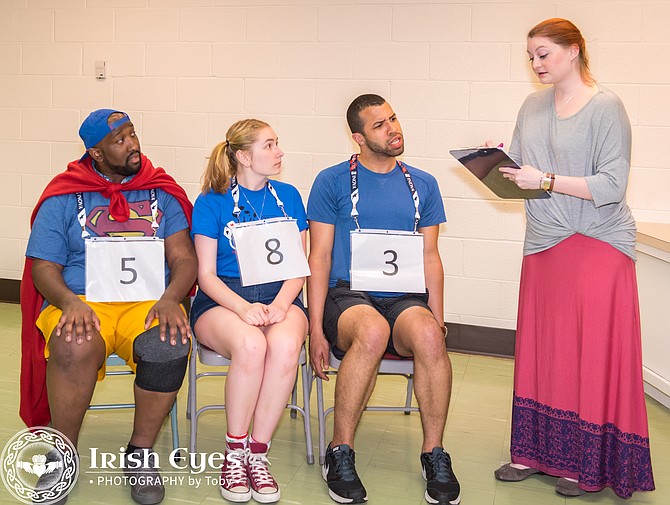 “The 25th Annual Putnam County Spelling Bee” — Three of the spellers (Sidney Davis, Sierra Hoffman, and William Jeffreys) are given instructions by Rona Lisa Peretti (Sara Watson).
