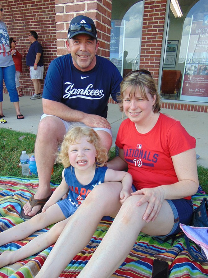 Tim, Betsy and Natalie Moore of Burke wait for the fireworks celebration at the Workhouse Arts Center in Lorton on Saturday July 1. 