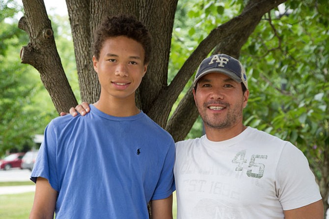 Adrien Cushing and his father Kenny pose for a picture outside of Great Falls library. 