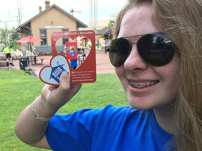 Sophia Skiavo, 15,  of Chantilly volunteers at Herndon Community Television.  She tested one of HCTV's  photo magnets to frame an image of her mom, Amy Skiavo, and the iconic Herndon Depot. The photo frame magnet is part of HCTV's new Social Media outreach campaign, “Share Your #HCTVLove of Herndon.”  
