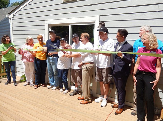 David Meyer cuts the ribbon on the Olivers’ rebuilt home in Fairfax.