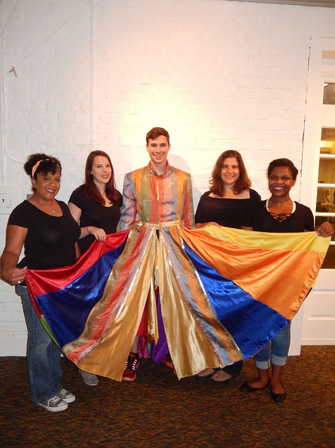 Wearing the musical’s iconic coat, Elijah King poses with “Joseph and the Amazing Technicolor Dreamcoat’s” narrators (from left) Bruni Herring, Peyton Avery, Allyson Jacob and Tatiane Jones.
