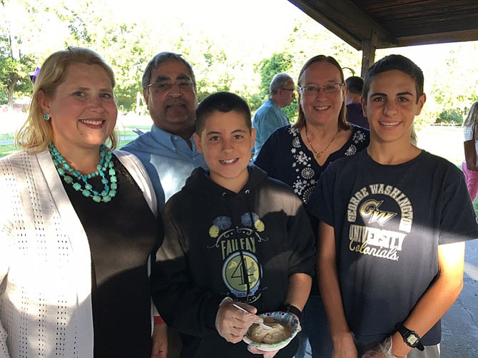 (Front row, from left) are Jennifer Passey and sons Liam, 12, and Eamon, 14; (back row) are her in-laws, Sahdev and Carolyn Passey, at the ice-cream social.