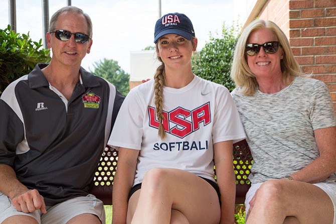 Kathryn Sandercock, rising senior at Bishop O’Connell High School, poses for a picture outside of McLean High School with her parents Colin and Trish Sandercock. This summer she was in Oklahoma pitching for the US Junior Women’s National Team.