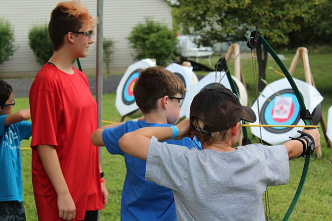 Cub Scouts try their hand at archery.