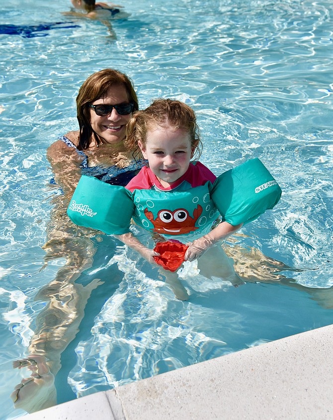 Christine Fantaskey with her  granddaughter Greer Heatherington enjoy the sun and water at River Falls community pool last weekend.