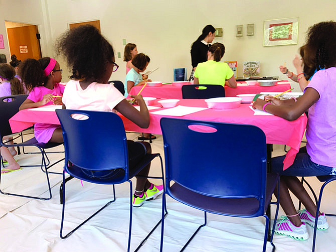 At a watercolor painting event for children on Monday, the artists are at work.