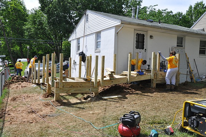 Volunteers install a ramp to Sam Avery’s front door and made other repairs that improved the safety of his home.
