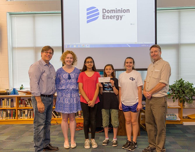 Students from Fairfax County’s Rachel Carson Middle School, the winning team in the Earth Force 2016-17 environment competition, hold the $5,000 financial gift that the Dominion Energy Charitable Foundation awarded to support Earth Force's 2017-18 competition. Vince Meldrum (far left), president & CEO of Earth Force, poses with Hayley Snowden (second from left), a representative from Dominion Energy's Media Relations team, and the students' teacher (far right).