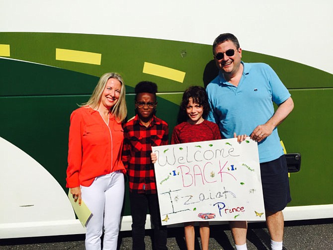 Potomac residents Sherry and Craig Beach and son Dalton welcome Izaiah from New York City who spent 18 days visiting with them through a Fresh Air program which allows inner city children to spend time with suburban or country families each summer.