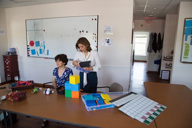 Mina Azari Kondner, director and Nahid Momenian, teacher at Mina’s School of Great Falls, display math teaching props that they use to help tutor children in math who may be struggling in public school. 
