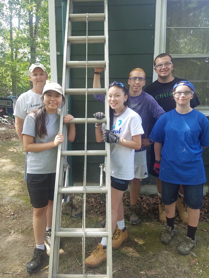 Lily McIntire to right of ladder with crew members at the Diocese of Arlington’s WorkCamp 2017.
