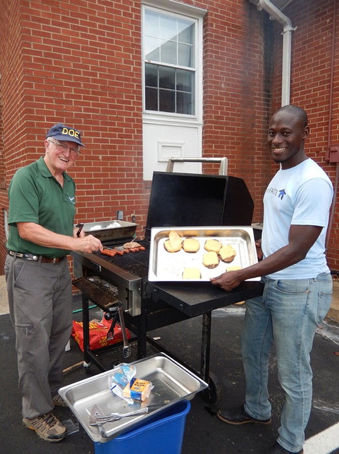 Henry Weigel (left) and Tijani Musa grill hot dogs and hamburgers for Ragan Oaks’s National Night Out at Centerpointe Church in Fair Oaks.