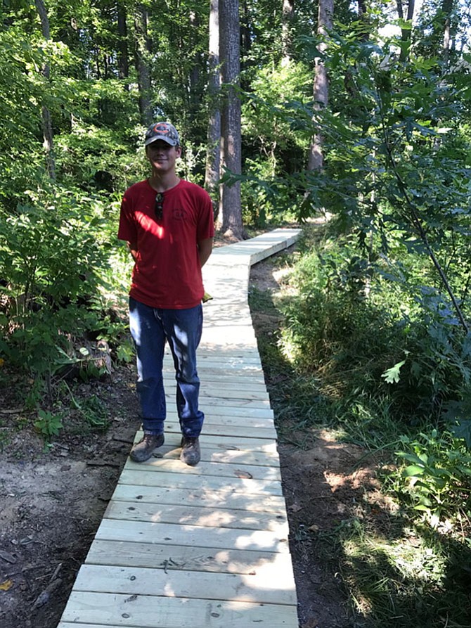 Life Scout Daniel Wozniak on the boardwalk in Gil McCutcheon Park.
