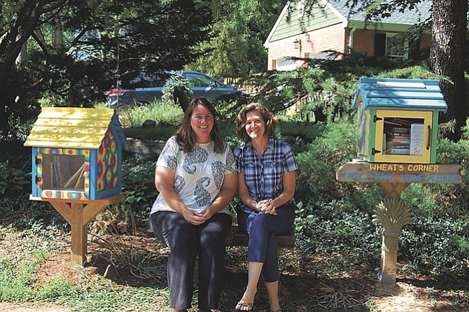 Liz Schroeder, left, and neighbor Eleanor Whitaker, at Liz’s library duplex in Riverside Gardens.