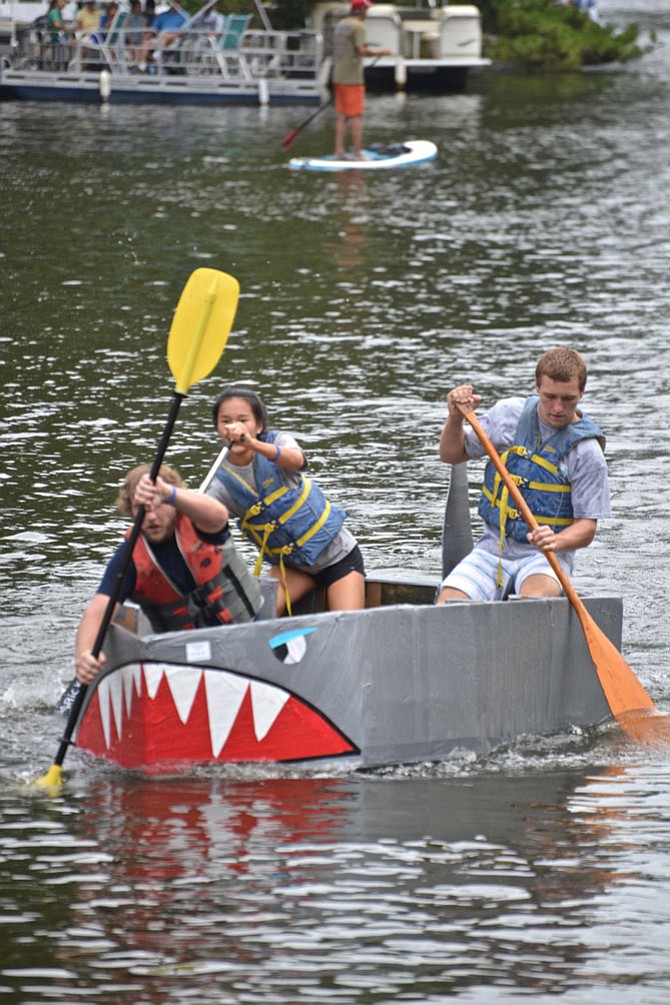 Team “What the Duct,” captained by Chad Levin, with mates Sky Lubreski and Olivia Rose of Reston, dig in deep as they head for the finish line. “What the Duct” won First Place in the Skipper Class for all-adult rowers.