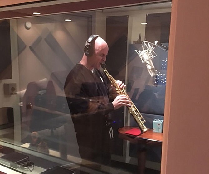 Fr. Keith O’Hare playing the saxophone during a recording session at Hobo Audio Co. studios in New York City.