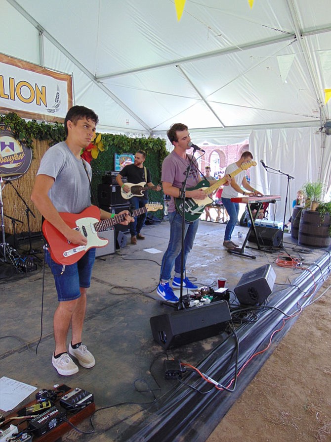 The band Virginia Man with lead singer Kristian Lietzan of Fredericksburg, Va., performs under the Pubvilion Tent.
