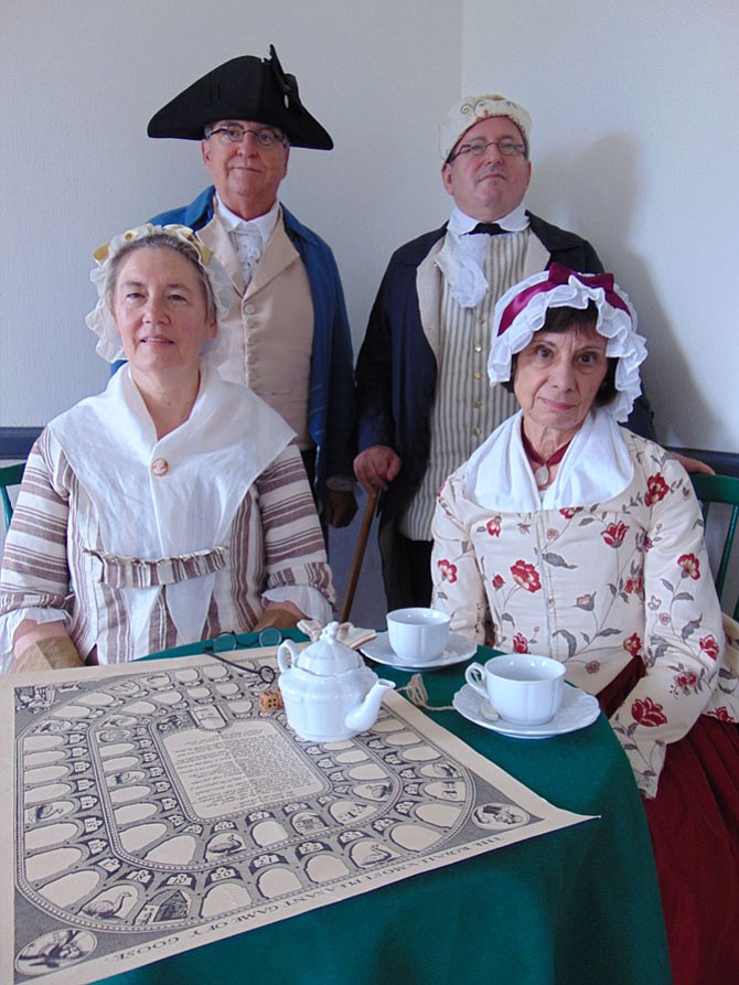 During the Summer Saturdays program at Gunston Hall, historic re-enactors discuss 18th century life at the former home of George Mason in Mason Neck.  Pictured are:  Mrs. Grace Newman, a.k.a. Carole Thomas; Elizabeth Westwood Wallace Mason, a.k.a. Emily Murphy; Thomson Mason, a.k.a. John Murphy; and Col. George Mason, a.k.a. Doug Cohen.