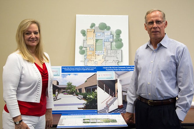 From left: Robin Walker, Social Media Editor for McLean Community Center, and George Sachs, Executive Director, pose next to plans for the renovation of the McLean Community Center Wednesday, Aug. 16.