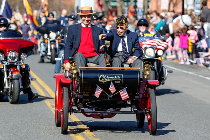 Alexandria is home to several signature events, including the George Washington Birthday Parade. This year World War II veteran Col. Kim Ching, right, waved to the crowd from Bob Geier’s 1903 Curved Dash Oldsmobile as the parade made its way through the streets of Old Town.
