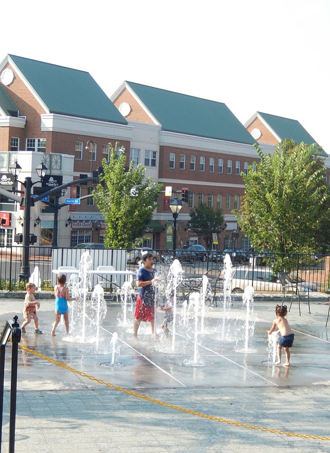 Children enjoying the splash pad in Fairfax City’s Old Town Square.