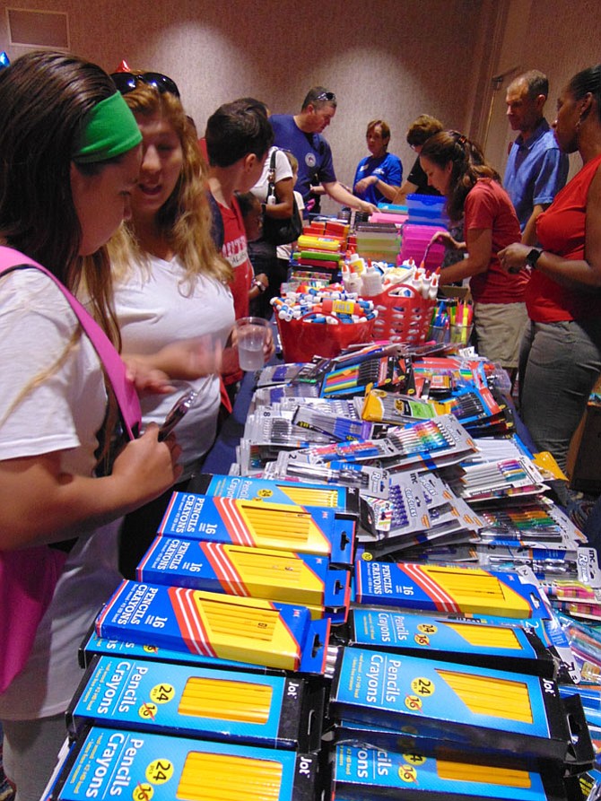 Children line up for school supplies at the Back-to-School Brigade, part of Operation Homefront at the Springfield Hilton Hotel on Saturday, Aug. 19.