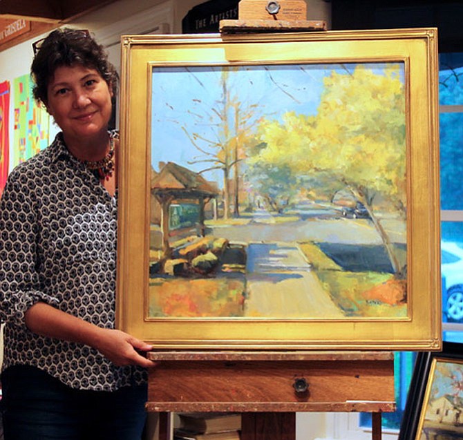 Oil Painter Jill Banks holds her painting, “Village Centre Walk,” which depicts Walker Road as it may look when the 17 newly-planted trees reach maturity. The donated painting is being raffled off by the Celebrate Great Falls Foundation to support the Streetscape Project. Up to 100 raffle tickets at $50 will be sold and can be purchased by credit card or via PayPal online at www.celebrategreatfalls.org/great-falls-streetscape.