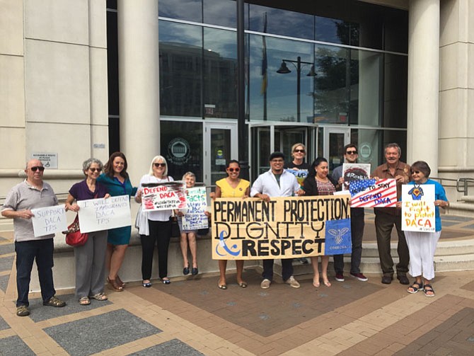 Activists rally outside Arlington County offices.