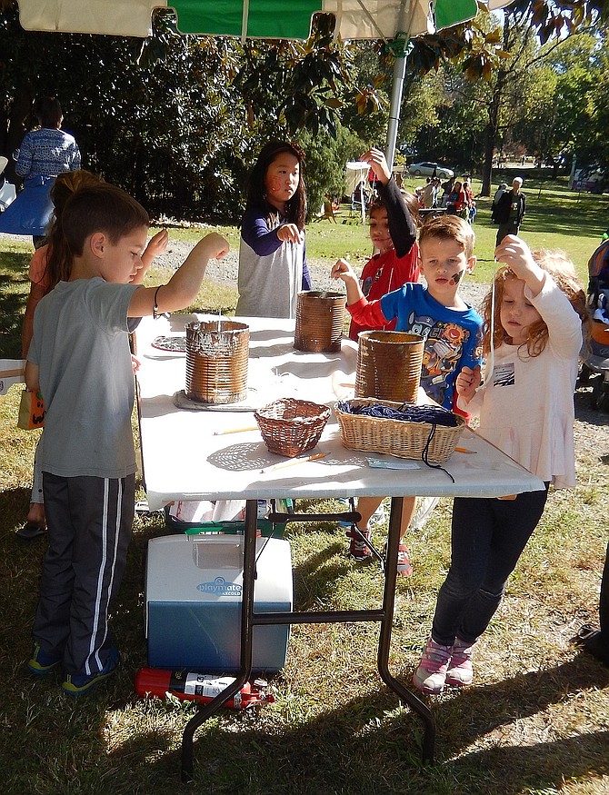 Children dip strings in wax to make candles during Centreville Day 2016. This year’s event is Oct. 21.