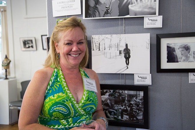 Laura Goyer, a Vienna Resident, and a photographer herself, was a judge for the show at the Vienna Arts Society on Saturday, Aug. 19. Here she stands next to some of her own work which was separate from the show.