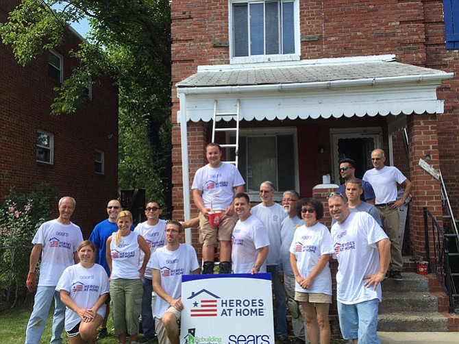 Rebuilding Together Alexandria volunteers gather at one of the houses repaired through a Sears’ Heroes at Home grant.
