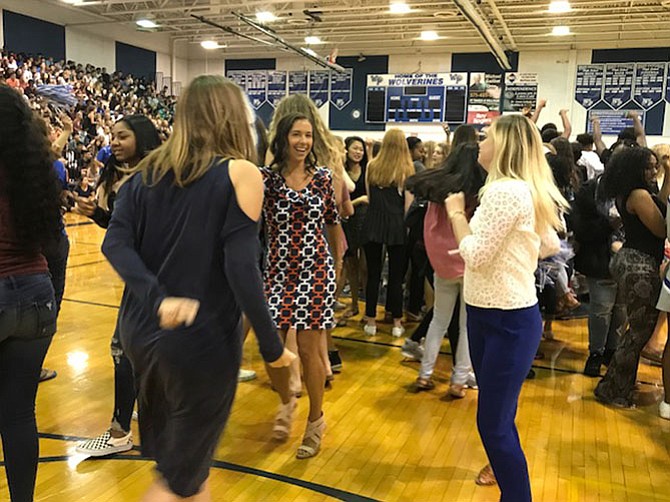 English Teachers Janna DeCoster (center) and Kelly Fontana (right) join in the fun at the back-to-school pep rally by showing off their moves and sharing a laugh.