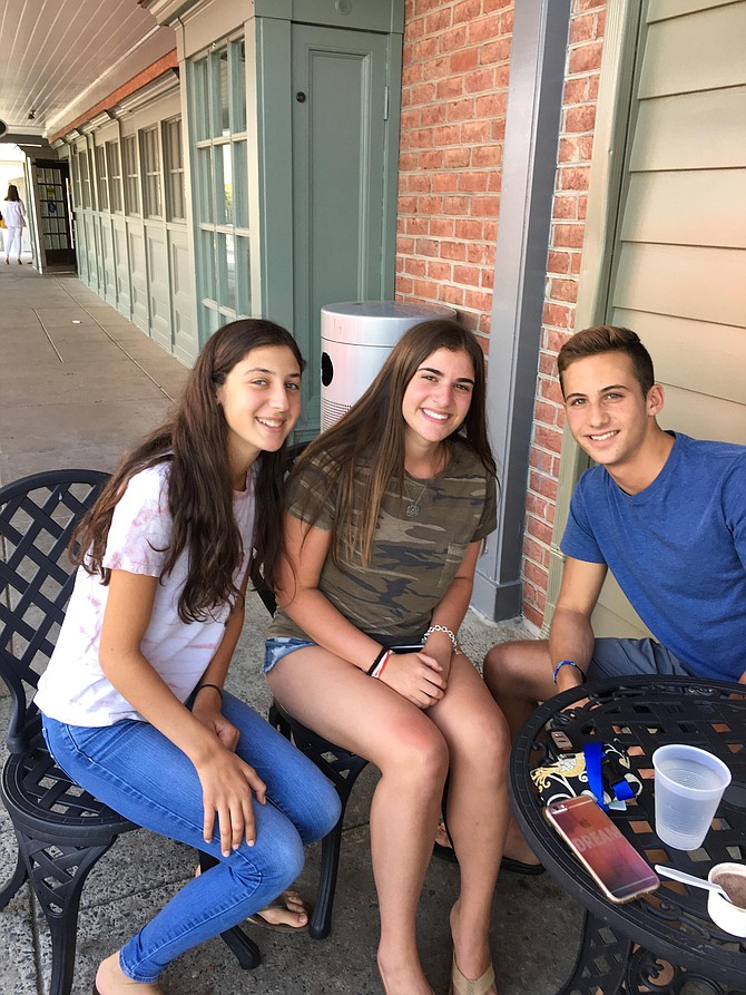 Lauren Katz, Emma Hocj and Ethan Missner, all rising juniors at Charles E. Smith Jewish Day School, meet in Potomac Village. The students went back to school on Tuesday.