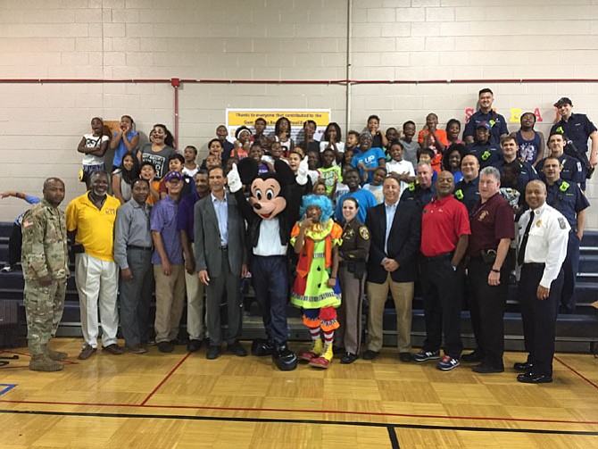 Volunteers gather for a group photo with attendees at the Gums Springs Community Day Aug. 23.