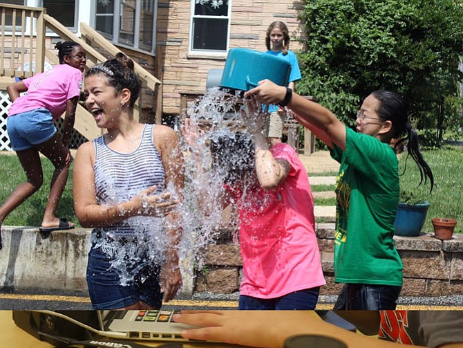 Campers take a break from the heat with a friendly water war.