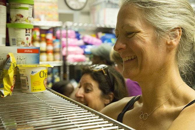 South Lakes High School Parent-Teacher-Student Association Member Amy Shaw organizes food at the pantry in July.