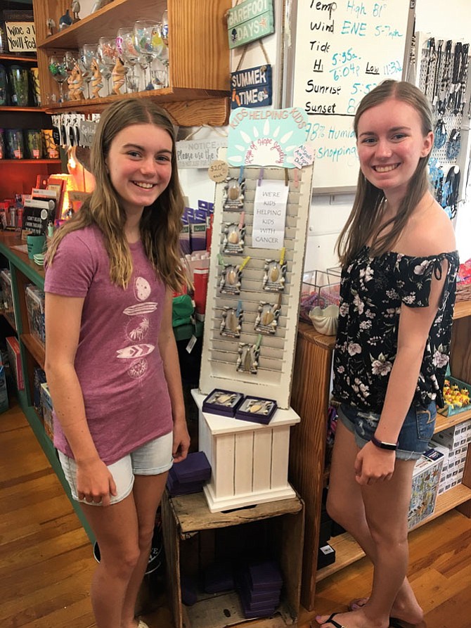 From left: Jenna, 12, and Cara Ainge, 14, of Reston sell their Rays of Hope Jewelry Collection at Duck's General Store in Kitty Hawk, N.C. The girls have raised $990 for CancerFree KIDS.
