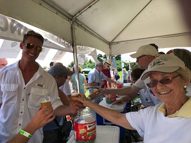 Charles H. Harbaugh, IV, Mayor of Middletown receives his craft beer sample from Gerri Ludwig, Herndon Woman's Club, at the Labor Day Festival.