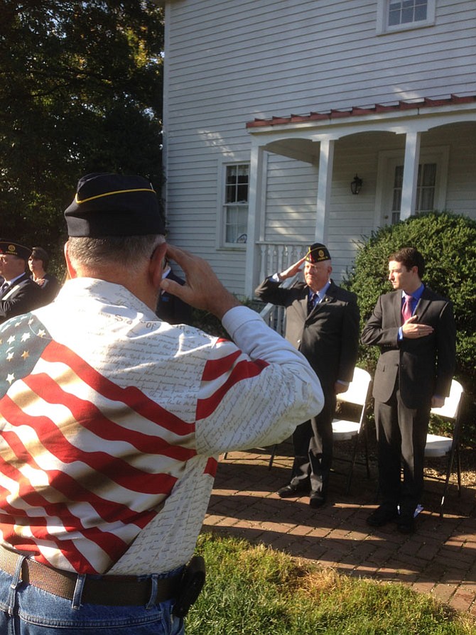 A Legionnaire and the keynote speaker — Vienna resident Jerry Driscoll — salute the flag at the Monday morning Patriot Day Community Commemoration in Vienna.